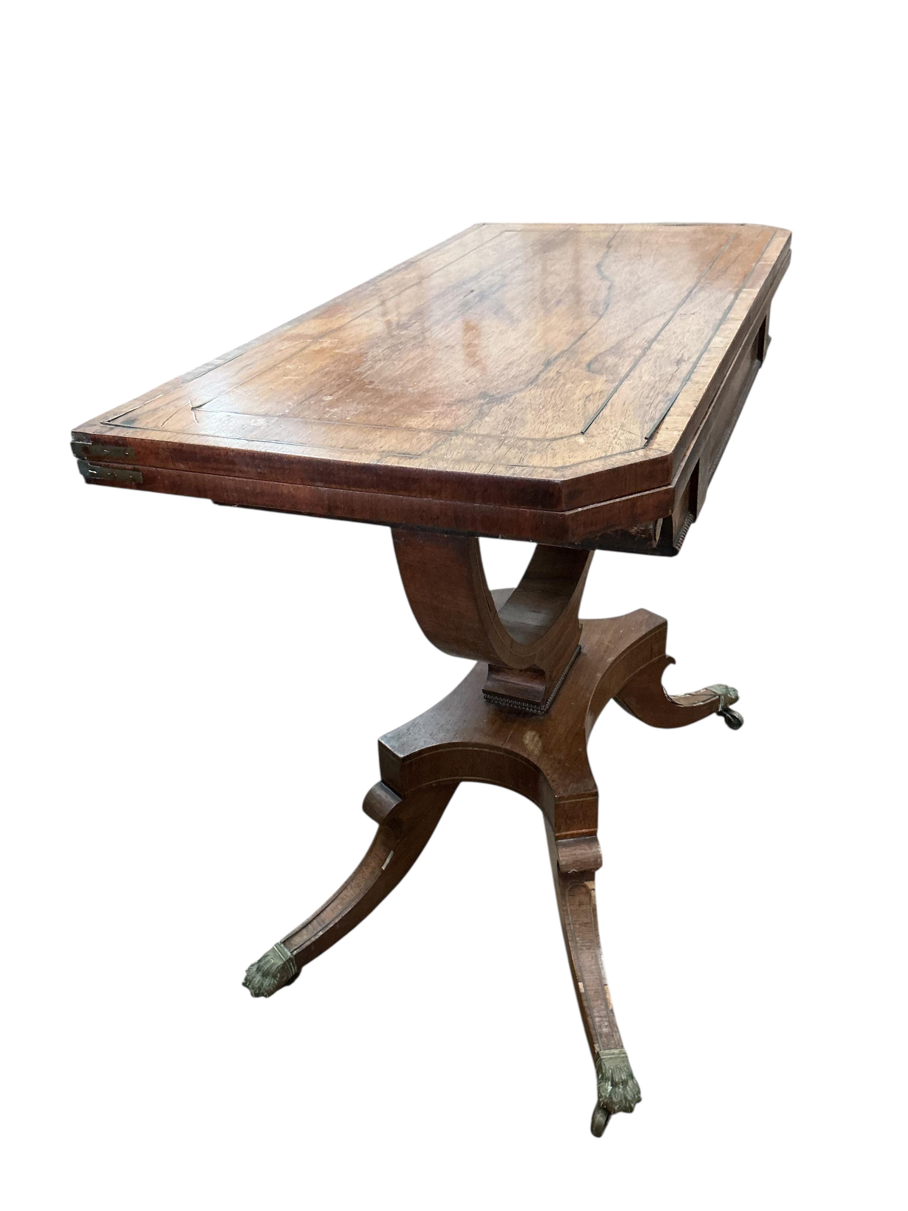 A Regency brass mounted rosewood folding card table, width 89cm, depth 44cm, height 74cm